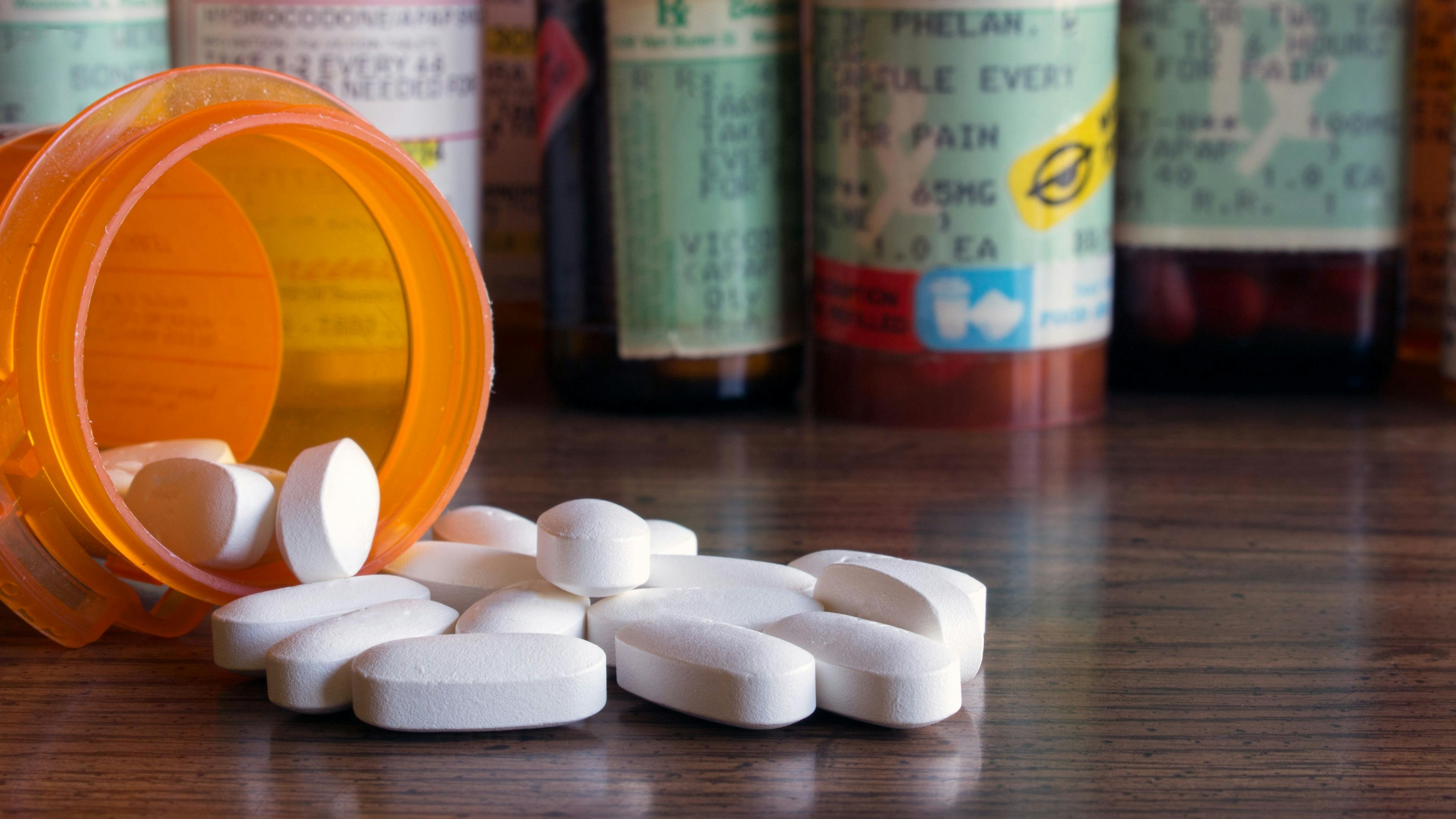 Prescription opioids with many bottles of pills in the bBackground. Concepts of addiction, opioid crisis, overdose and doctor shopping - Image credit: Kimberly Boyles | stock.adobe.com