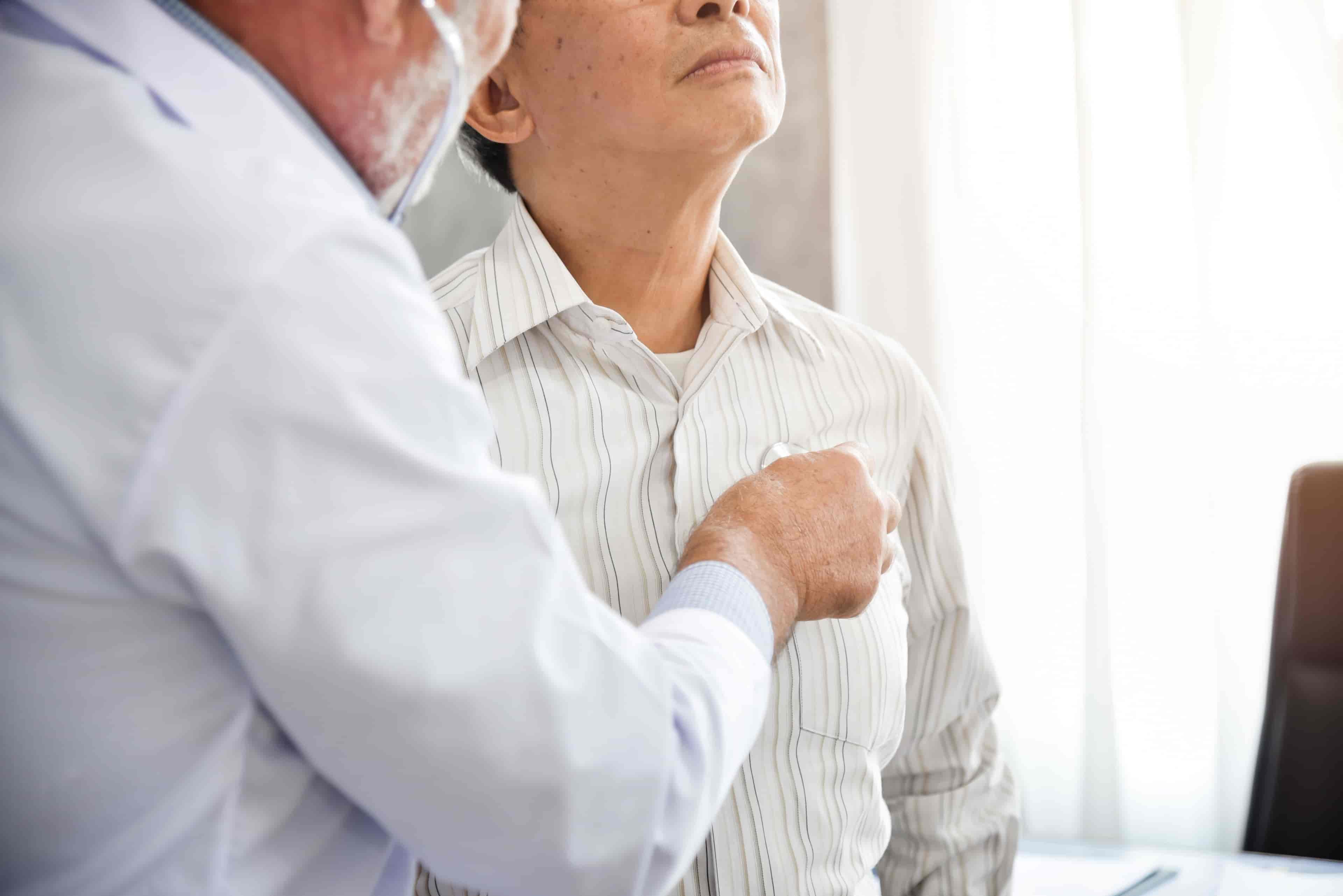 Senior Doctor is examining An Asian patient.