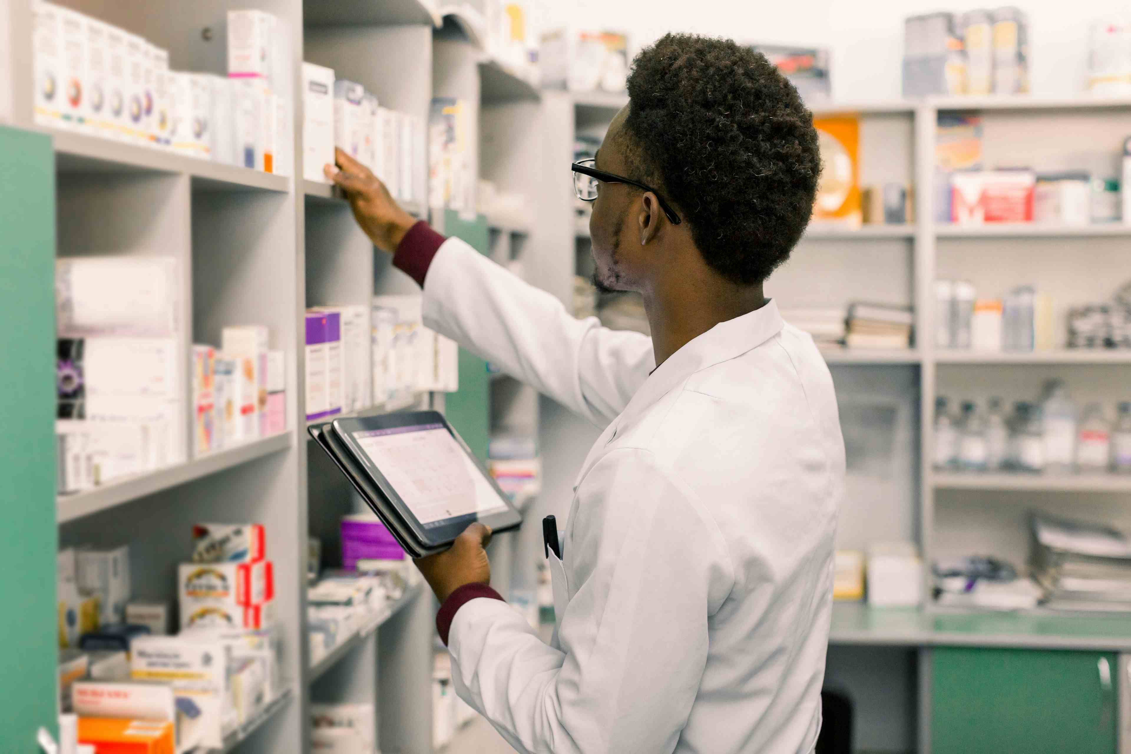 African American male pharmacist using digital tablet during inventory in pharmacy - Image credit: sofiko14 | stock.adobe.com