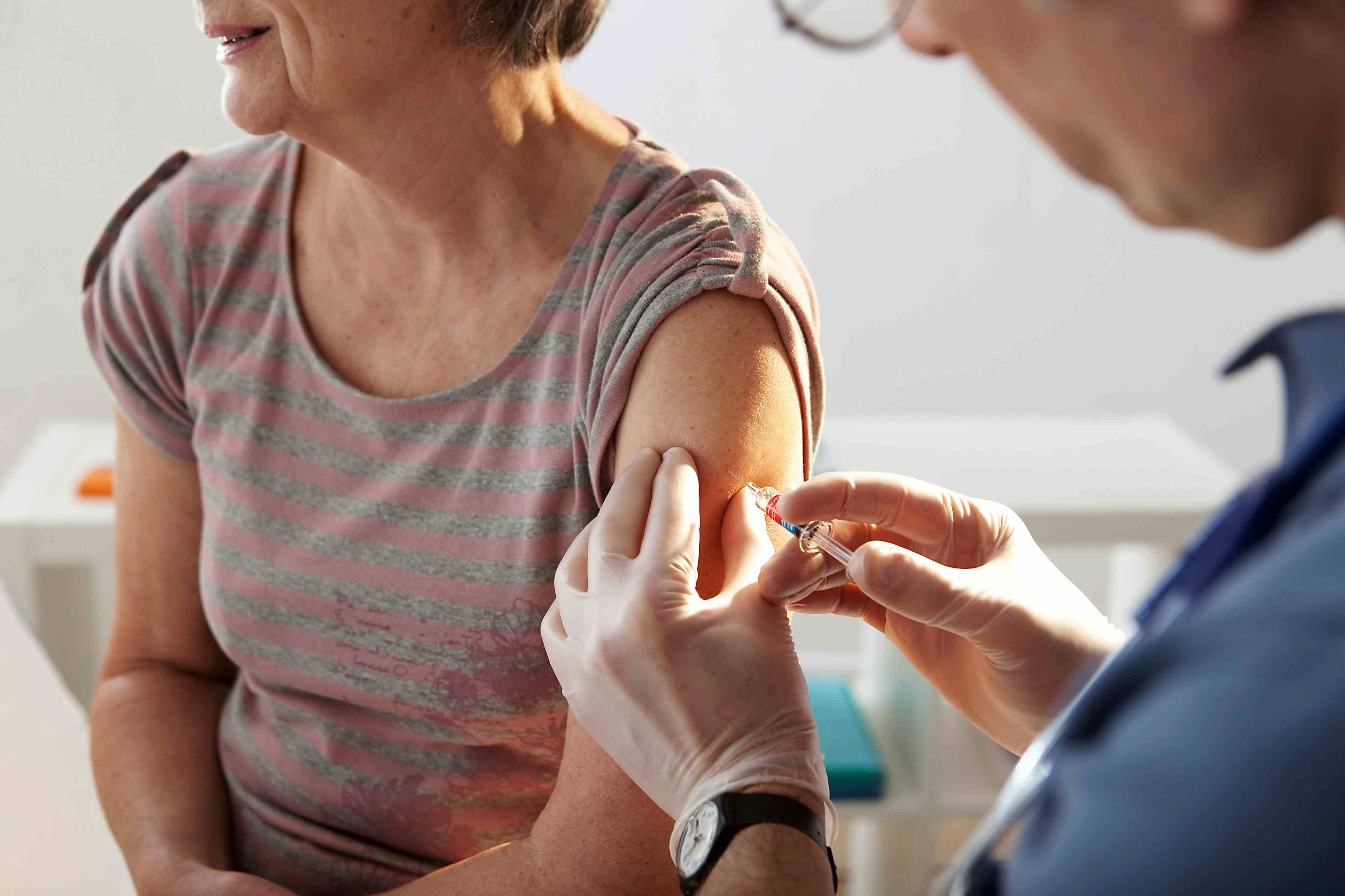 Vaccinating an elderly person.