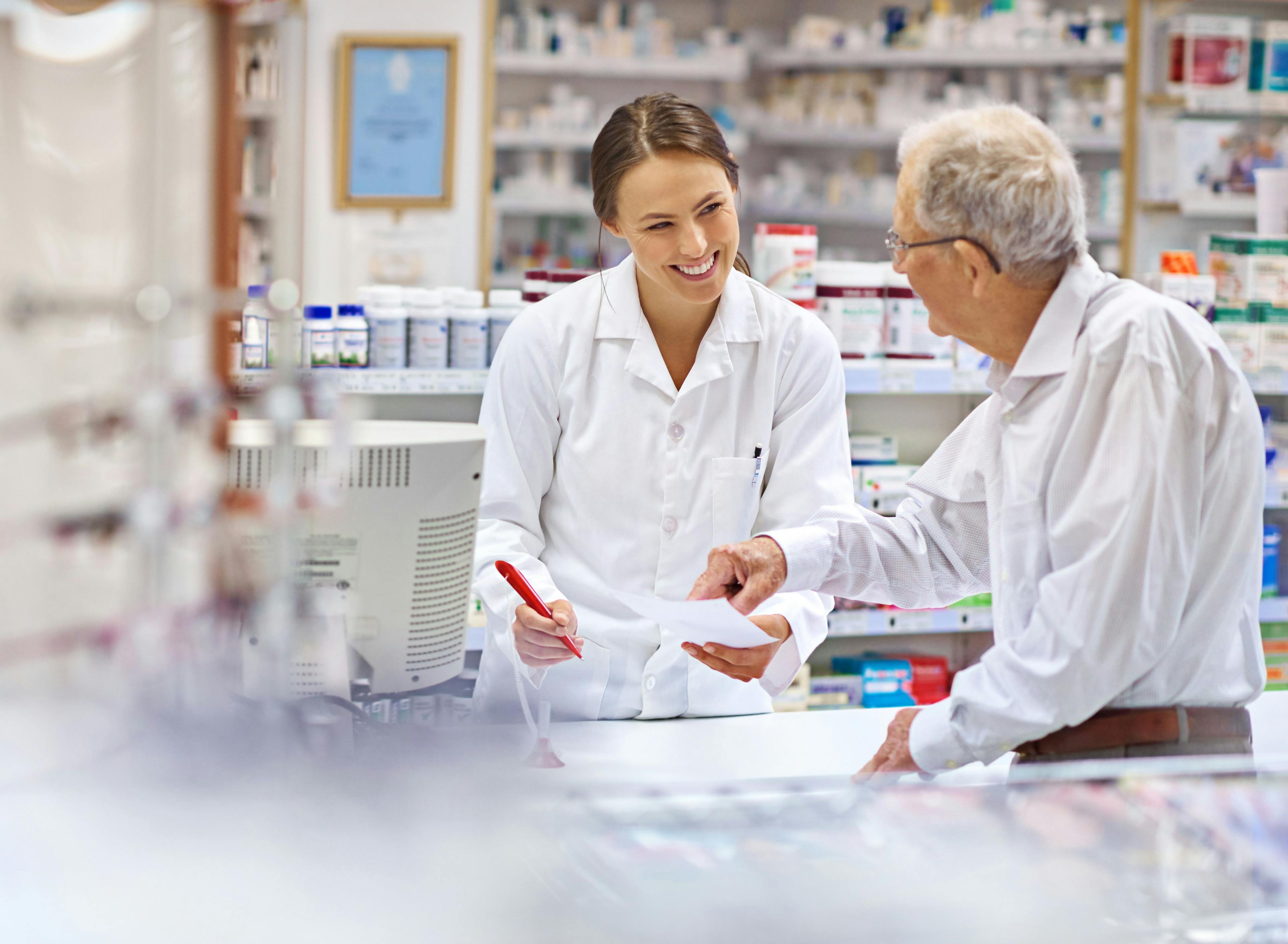 Pharmacist helping a patient -- Image credit: Yuri Arcurs/peopleimages.com | stock.adobe.com
