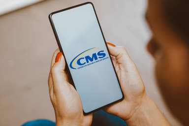 In this photo illustration, the Centers for Medicare and Medicaid Services (CMS) logo is displayed on a smartphone screen.