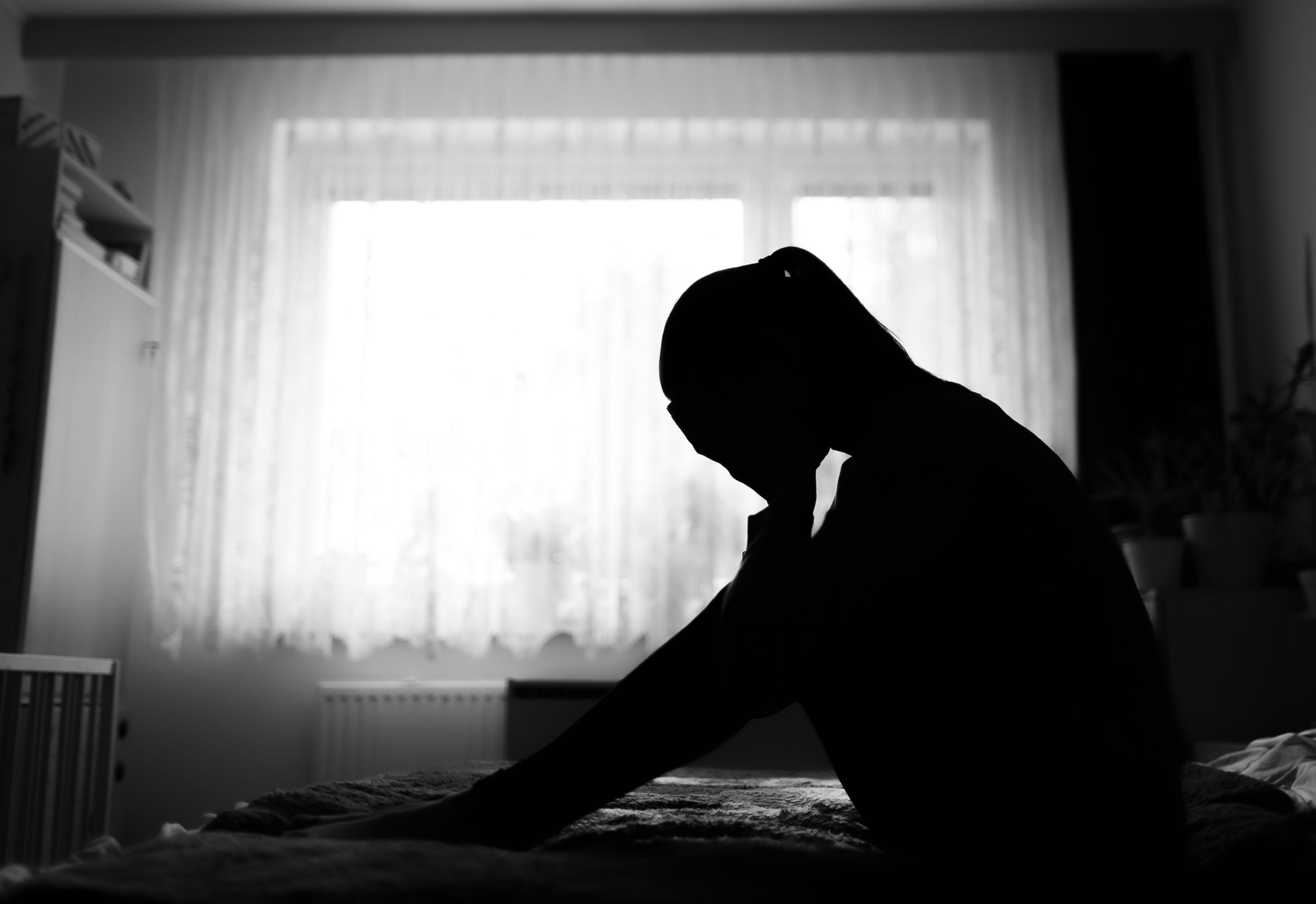 Woman sitting on the floor with depression, postpartum depression