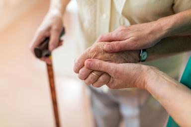 Health care provider holding the hands of an elderly woman -- Image credit: pikselstock | stock.adobe.com