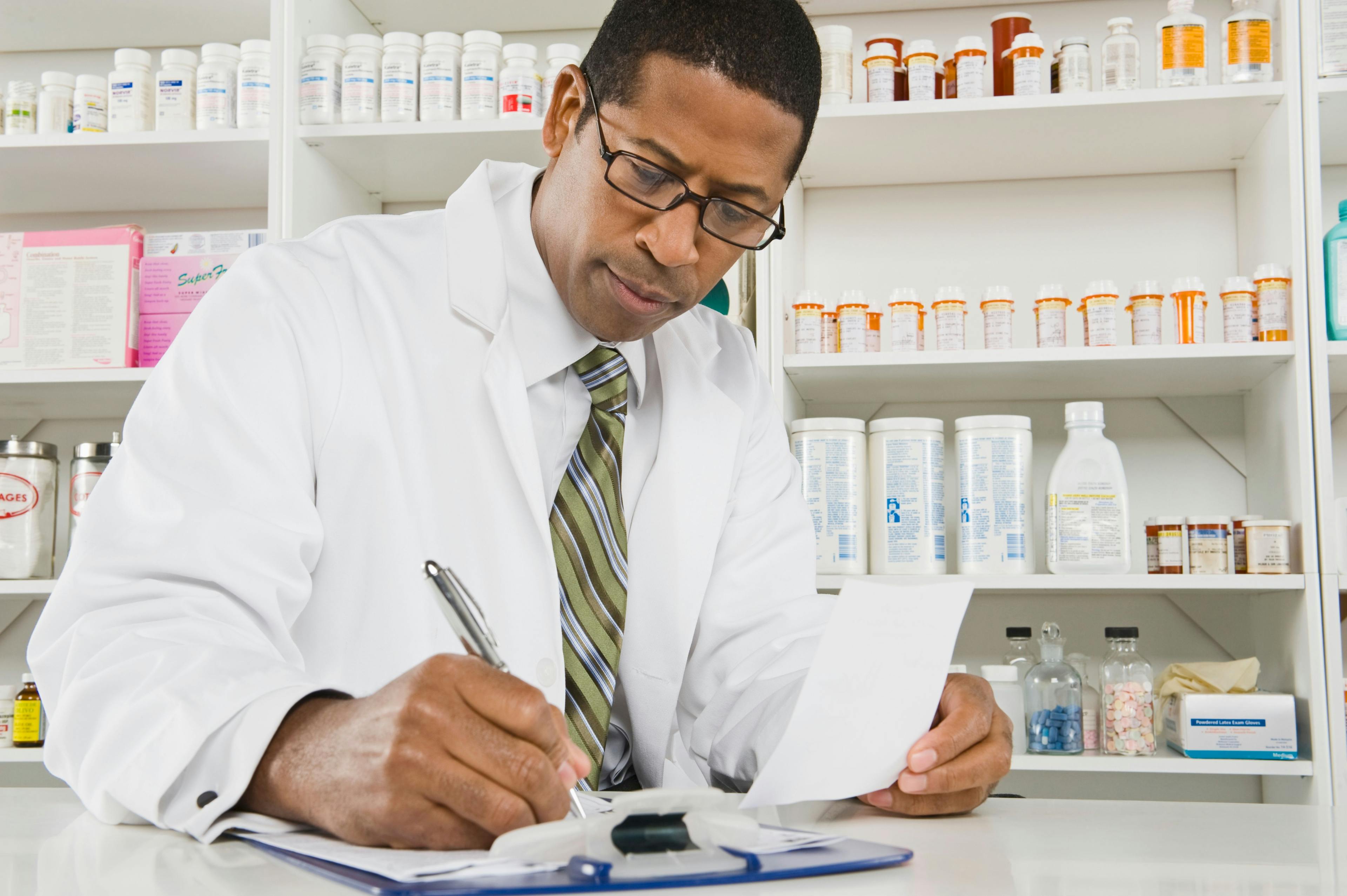 Pharmacist writing on a clipboard -- Image credit: moodboard | stock.adobe.com