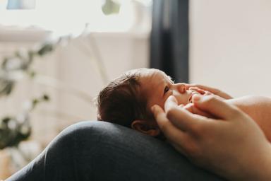 Parent holding newborn baby -- Image credit: annaperevozkina | stock.adobe.com