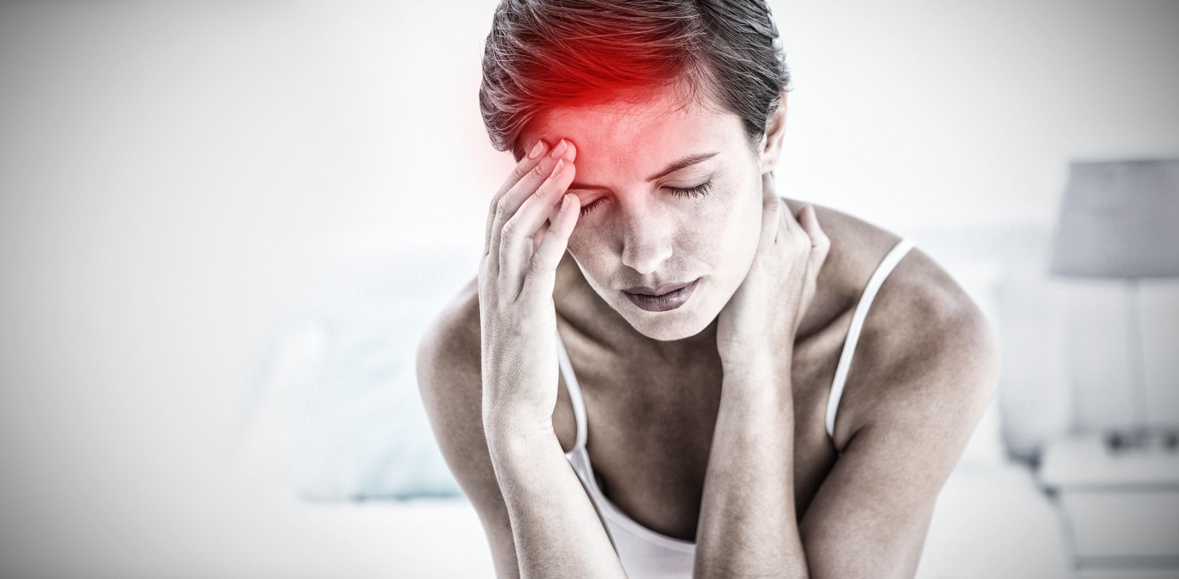 Woman suffering from a migraine, holding her head