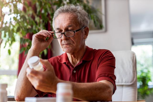 Senior man taking prescription medicine at home - Image credit: pikselstock | stock.adobe.com 