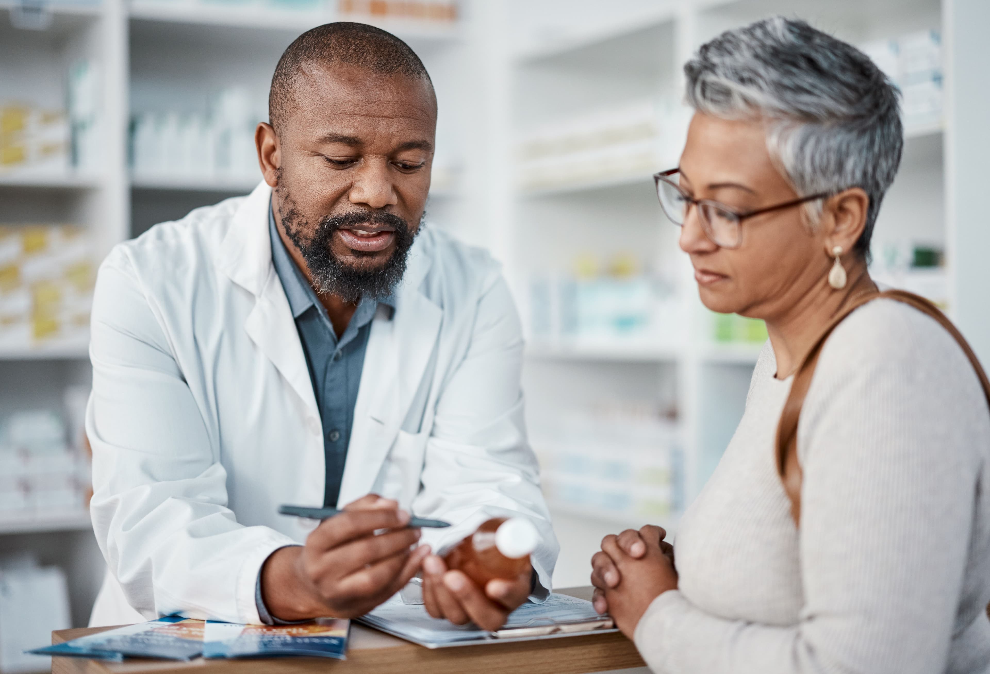 Pharmacist helping patient -- Image credit: Clayton D/peopleimages.com | stock.adobe.com