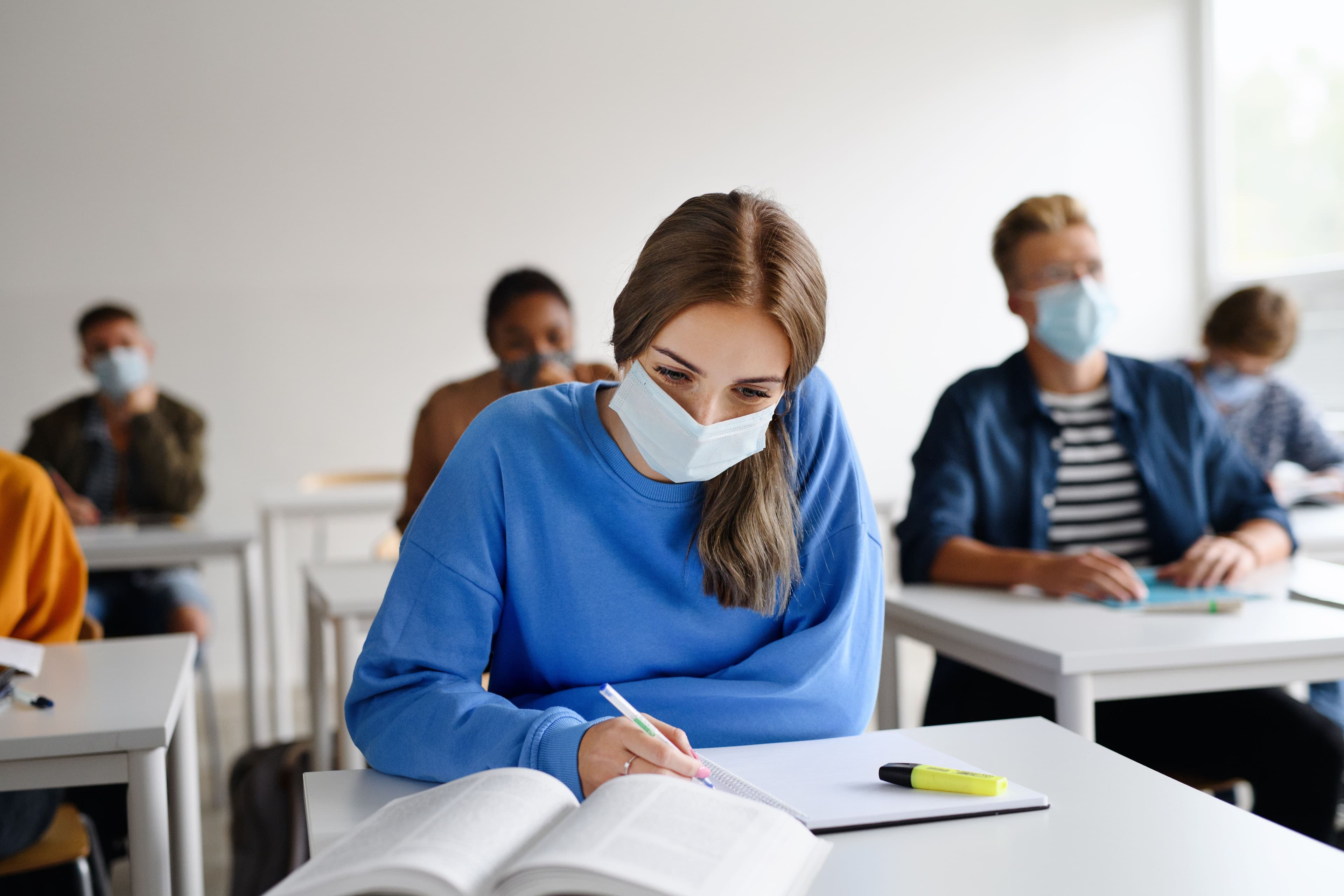 College student wearing face mask during class -- Image credit: Halfpoint | stock.adobe.com