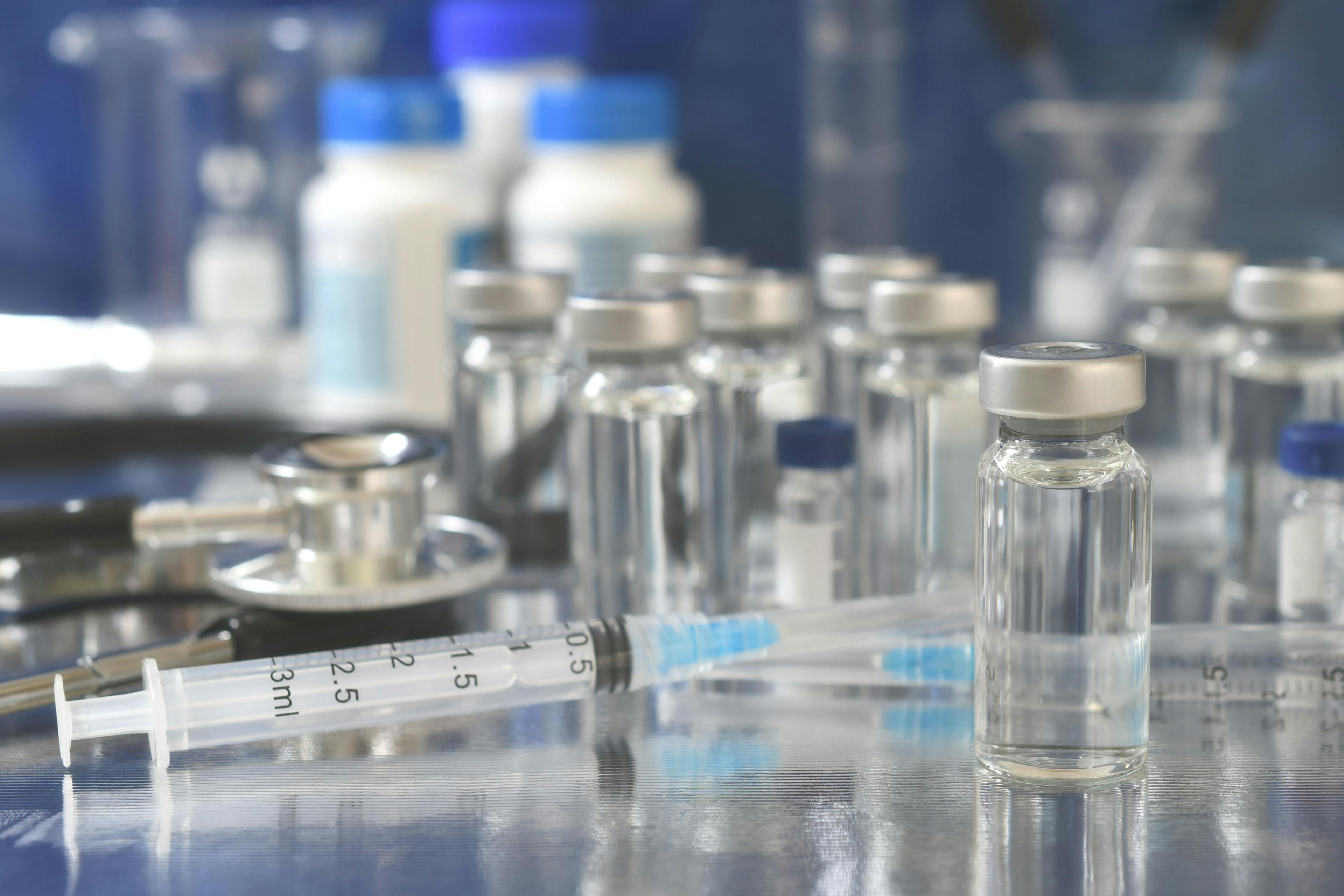 Vials of generic vaccines with syringe and stethoscope.