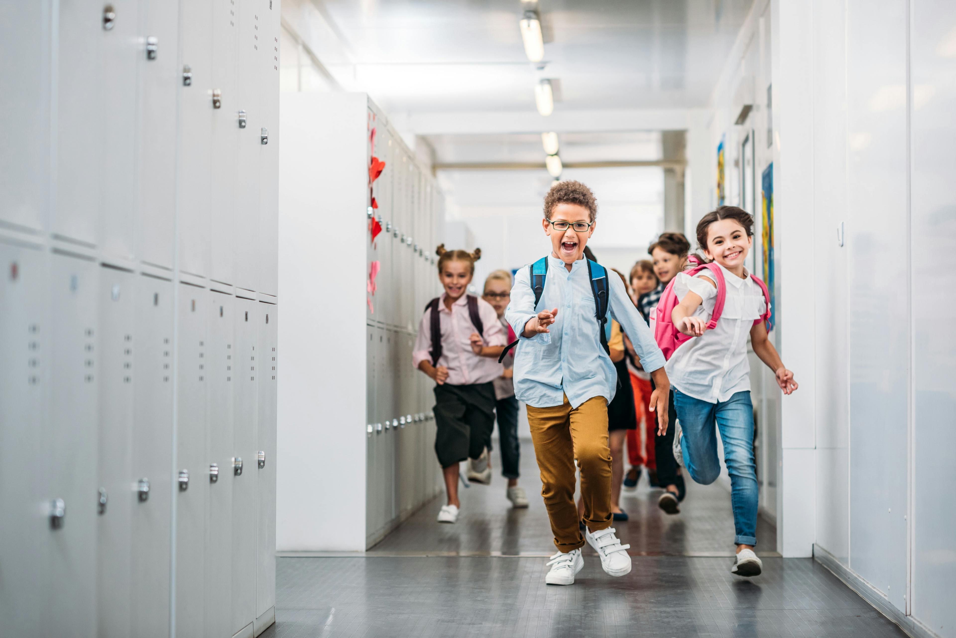 Pupils running through school corridor - Image credit: LIGHTFIELD STUDIOS | stock.adobe.com