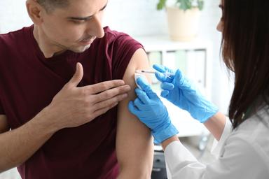 Man receiving vaccine -- Image credit: New Africa | stock.adobe.com