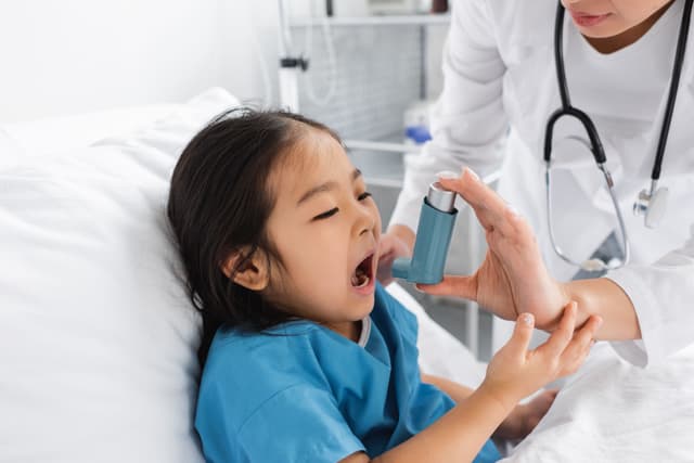 Child with asthma in hospital using inhaler -- Image credit: LIGHTFIELD STUDIOS | stock.adobe.com