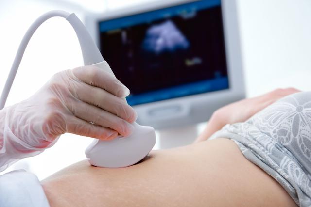 Woman receiving an ultrasound -- Image credit: Alexander Raths | stock.adobe.com