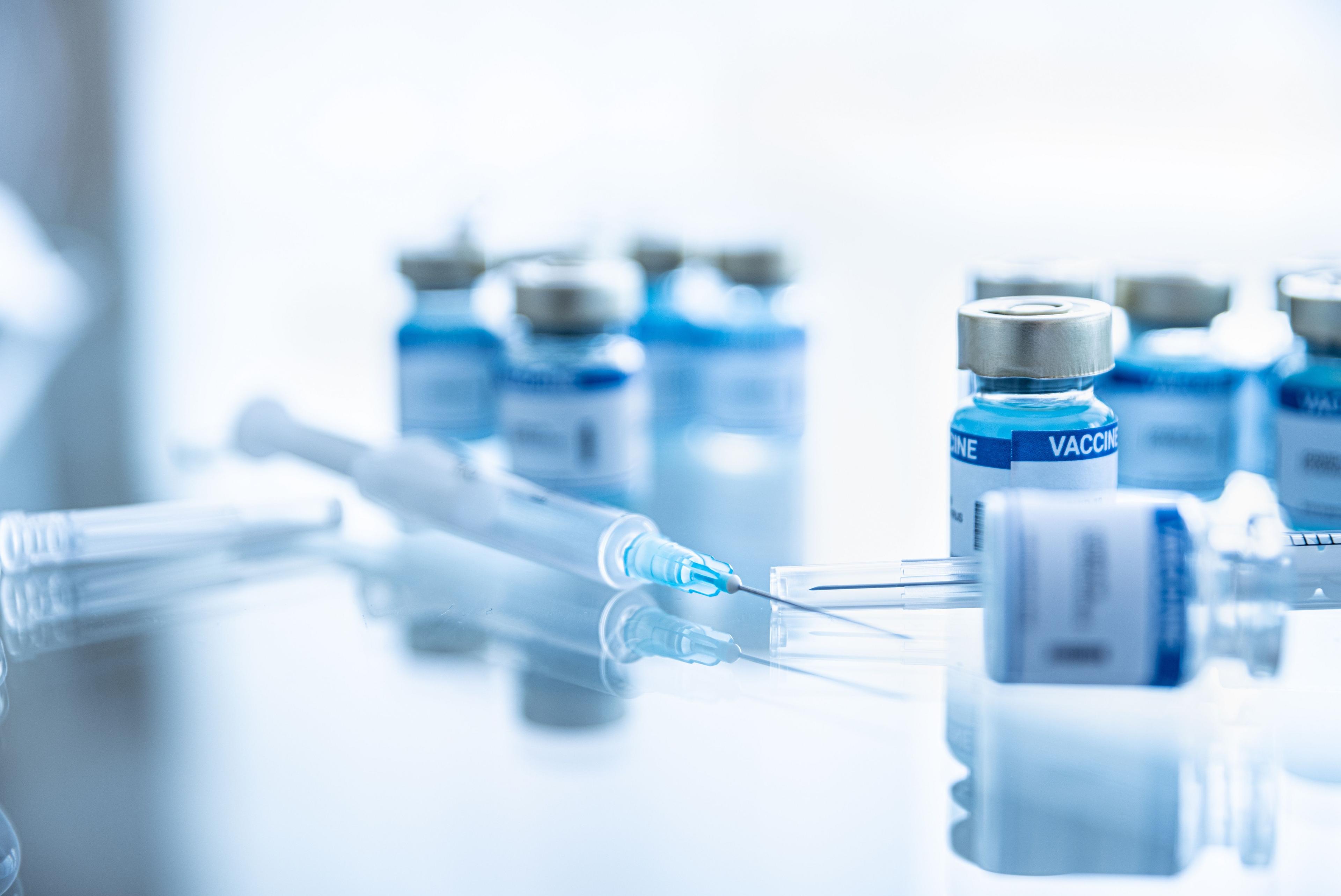 Some ampoules with covid-19 vaccine and syringe injection. Pandemic time. - Image credit: Daniel Jędzura | stock.adobe.com 