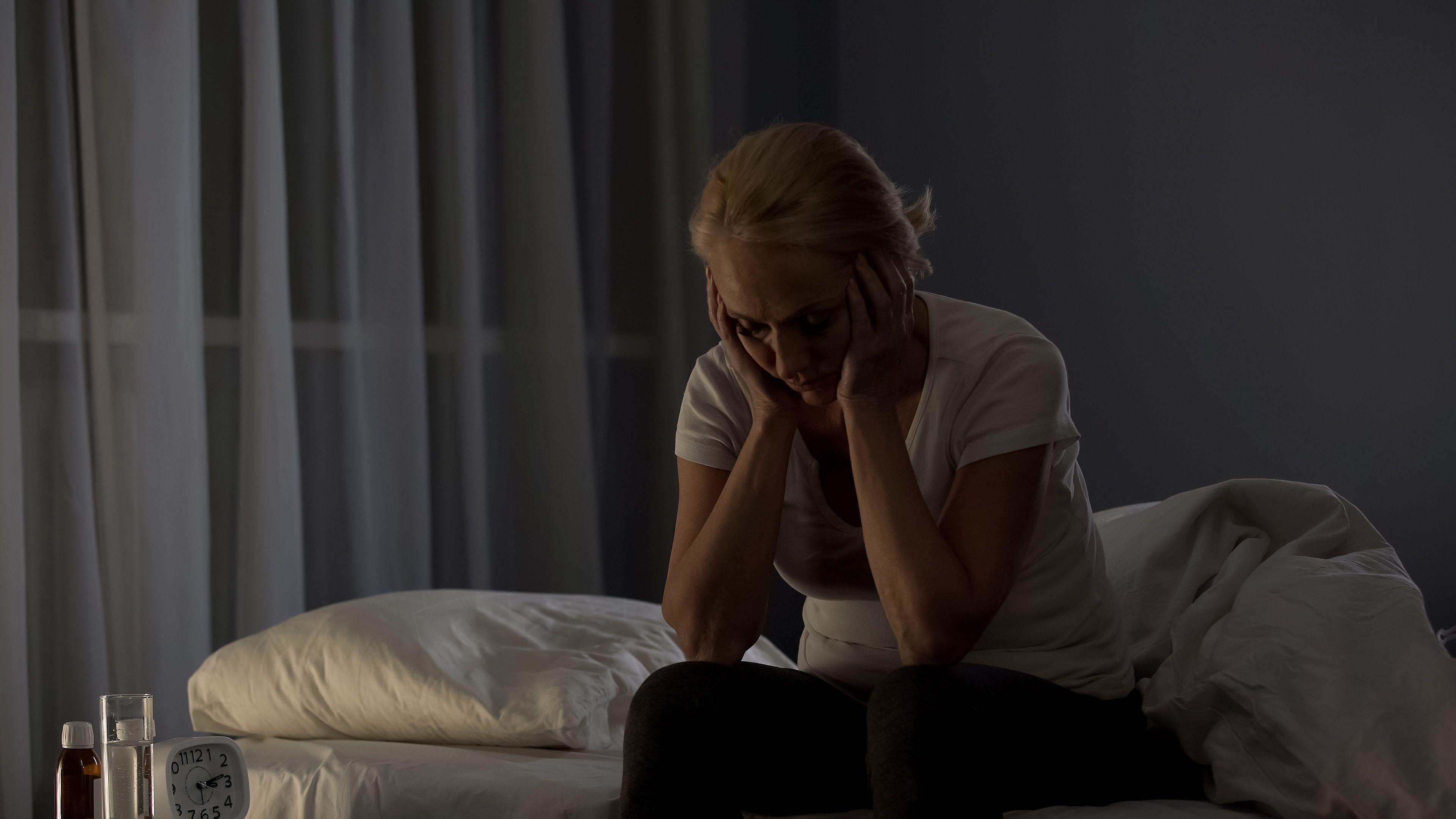 Tired middle-aged woman sitting on bed at night, insomnia disease, problem - Image credit: motortion | stock.adobe.com 