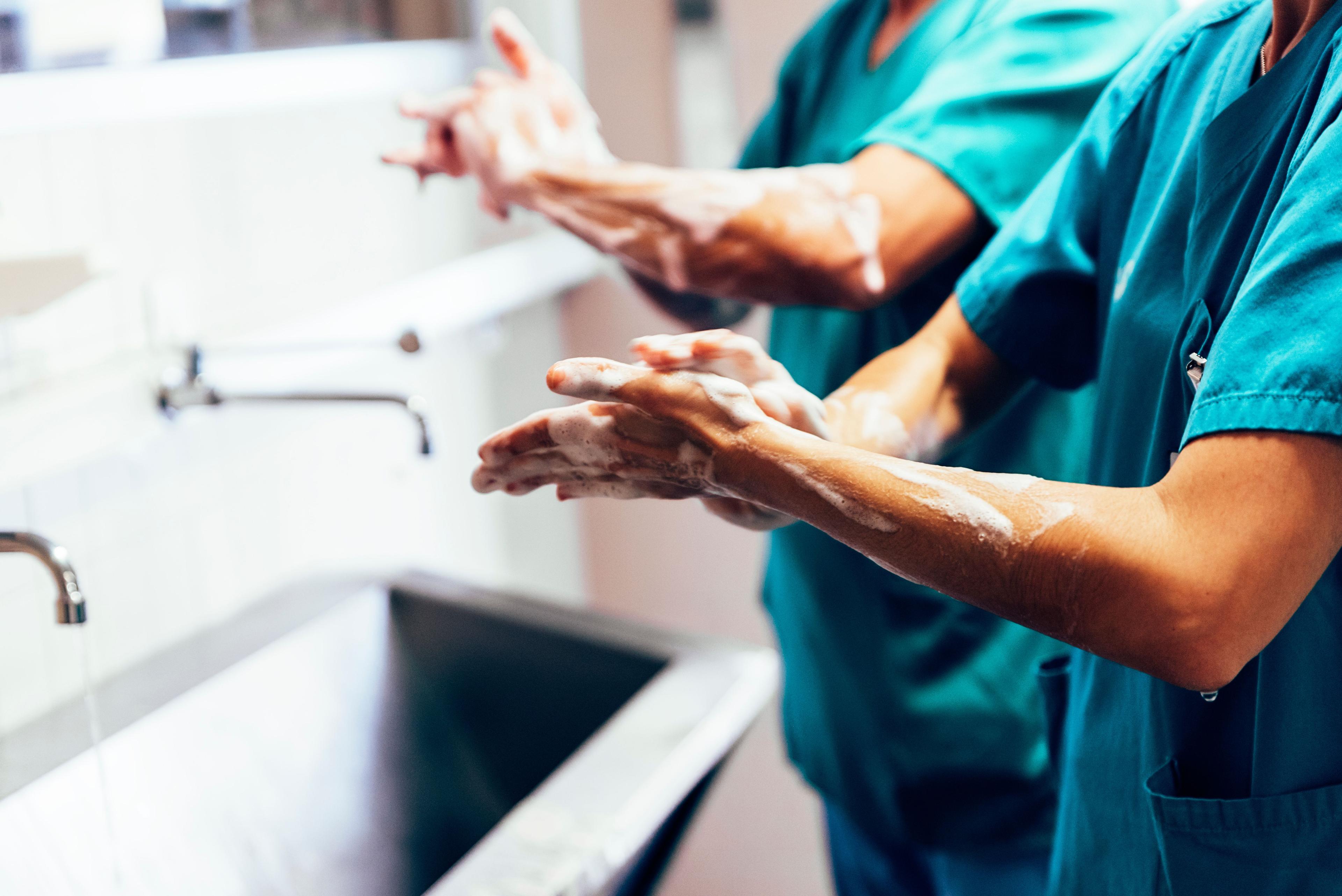 Couple of Surgeons Washing Hands Before Operating - Image credit: santypan | stock.adobe.com 