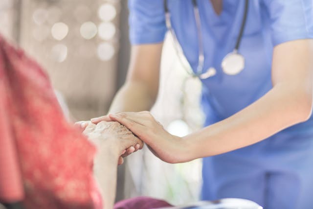 Hand of eldery woman with her caregiver at home. Home care or Elderly care concept - Image credit: chompoo | stock.adobe.com