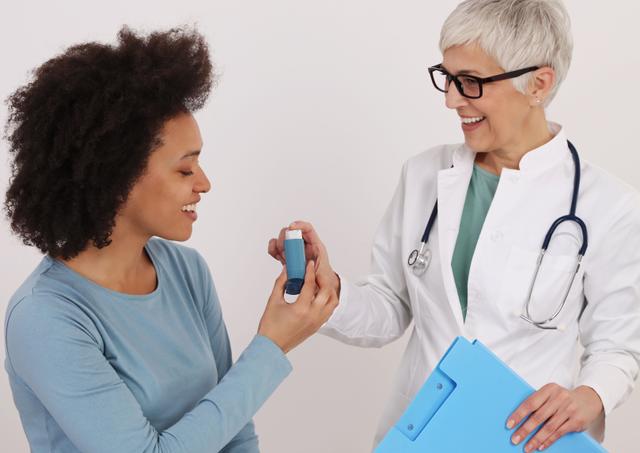 Patient receiving asthma inhaler from health care provider -- Image credit: dream@do | stock.adobe.com