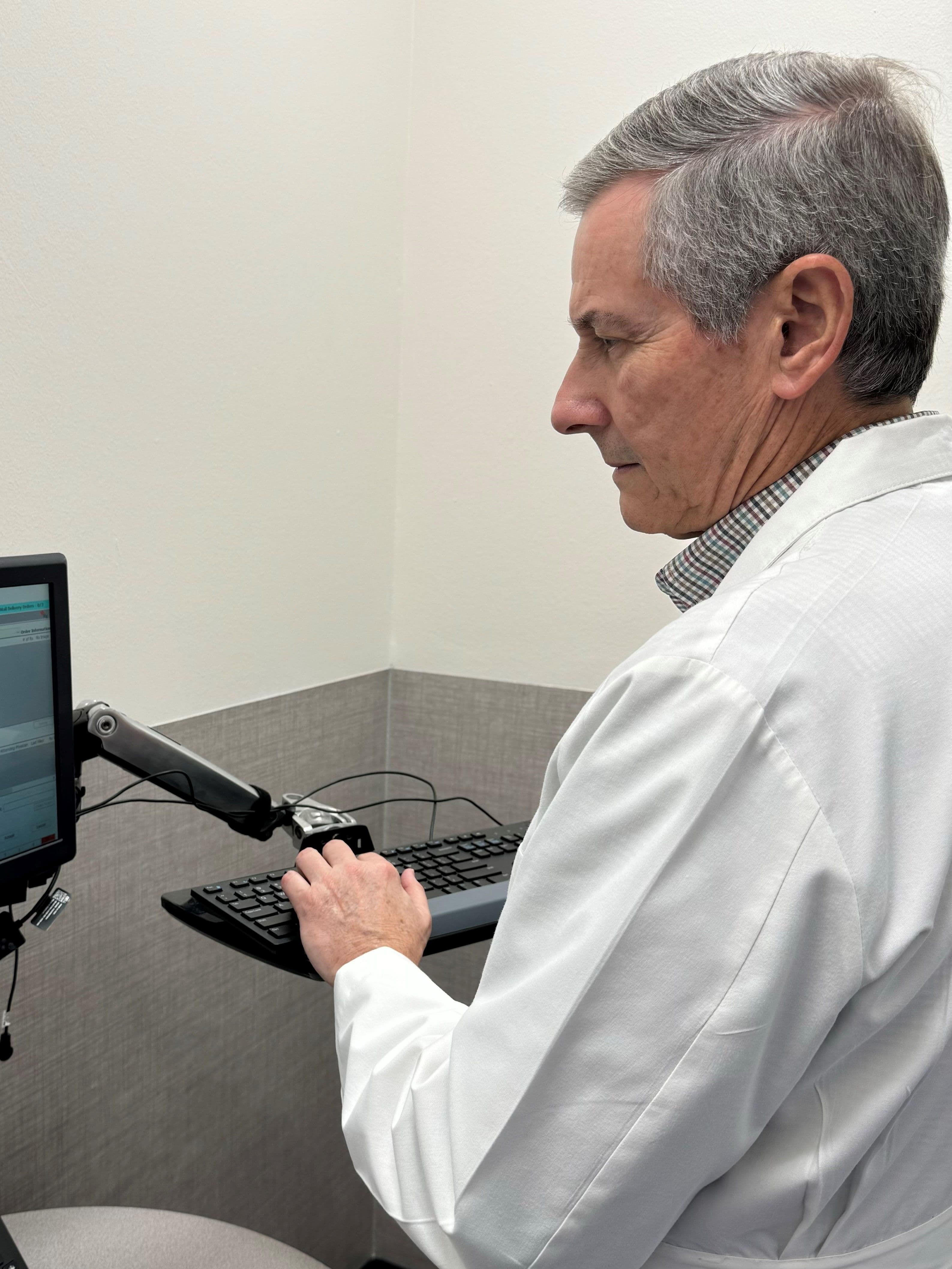 Frank Kessler at work at a computer at his Walmart pharmacy in Memphis.