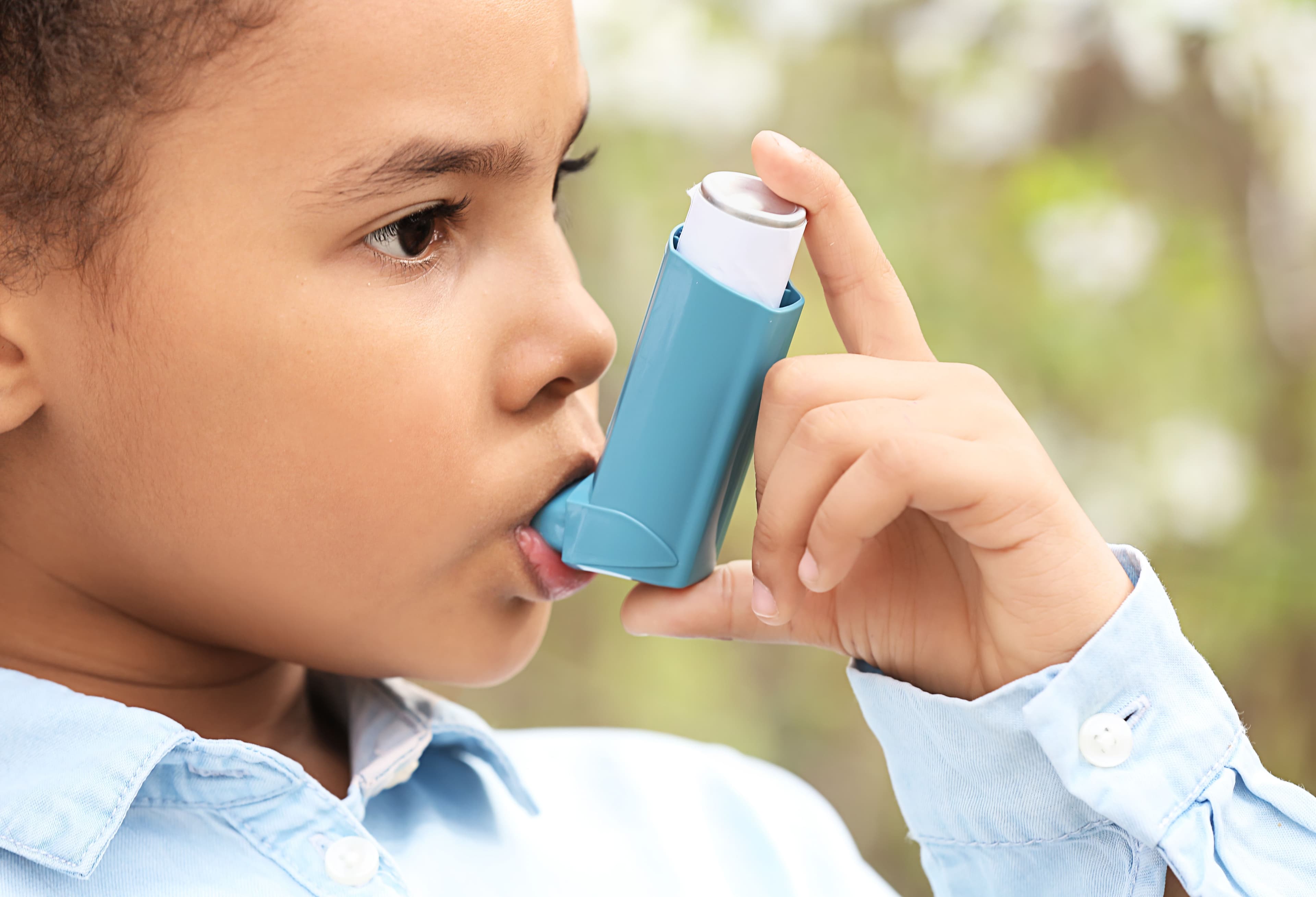 Young girl using an asthma inhaler -- Image credit: Pixel-Shot | stock.adobe.com