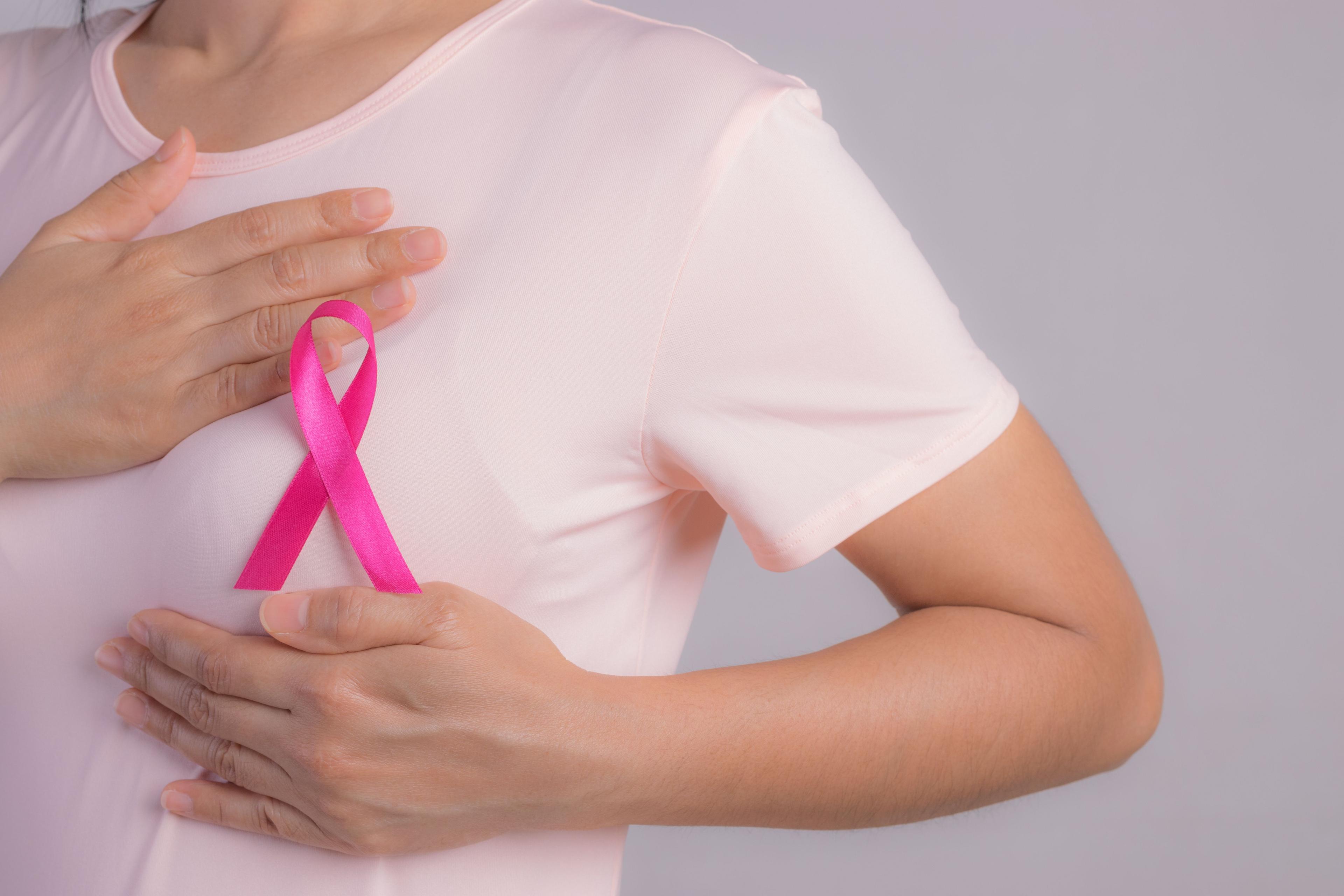 Woman wearing pink ribbon for breast cancer awareness -- Image credit: Phongsakorn | stock.adobe.com