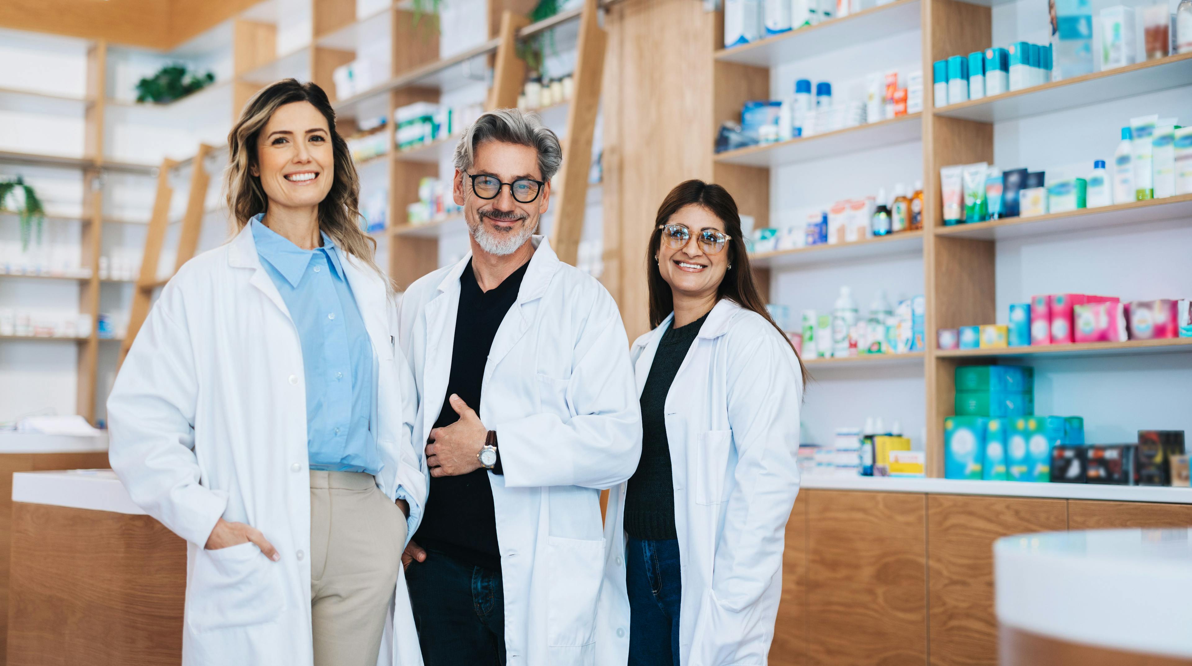 Three pharmacists standing together in a drug store - Image credit: Jacob Lund | stock.adobe.com 