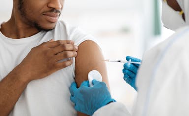 man receiving vaccine shot - Image credit:  Prostock-studio | stock.adobe.com 