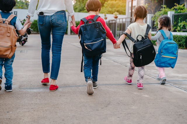 Back to School of Mother and pupil and kids holding hands going to school - Image credit: Kiattisak | stock.adobe.com 