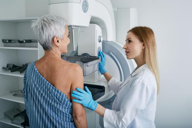 Female patient receiving a mammography -- Image credit: Peakstock | stock.adobe.com