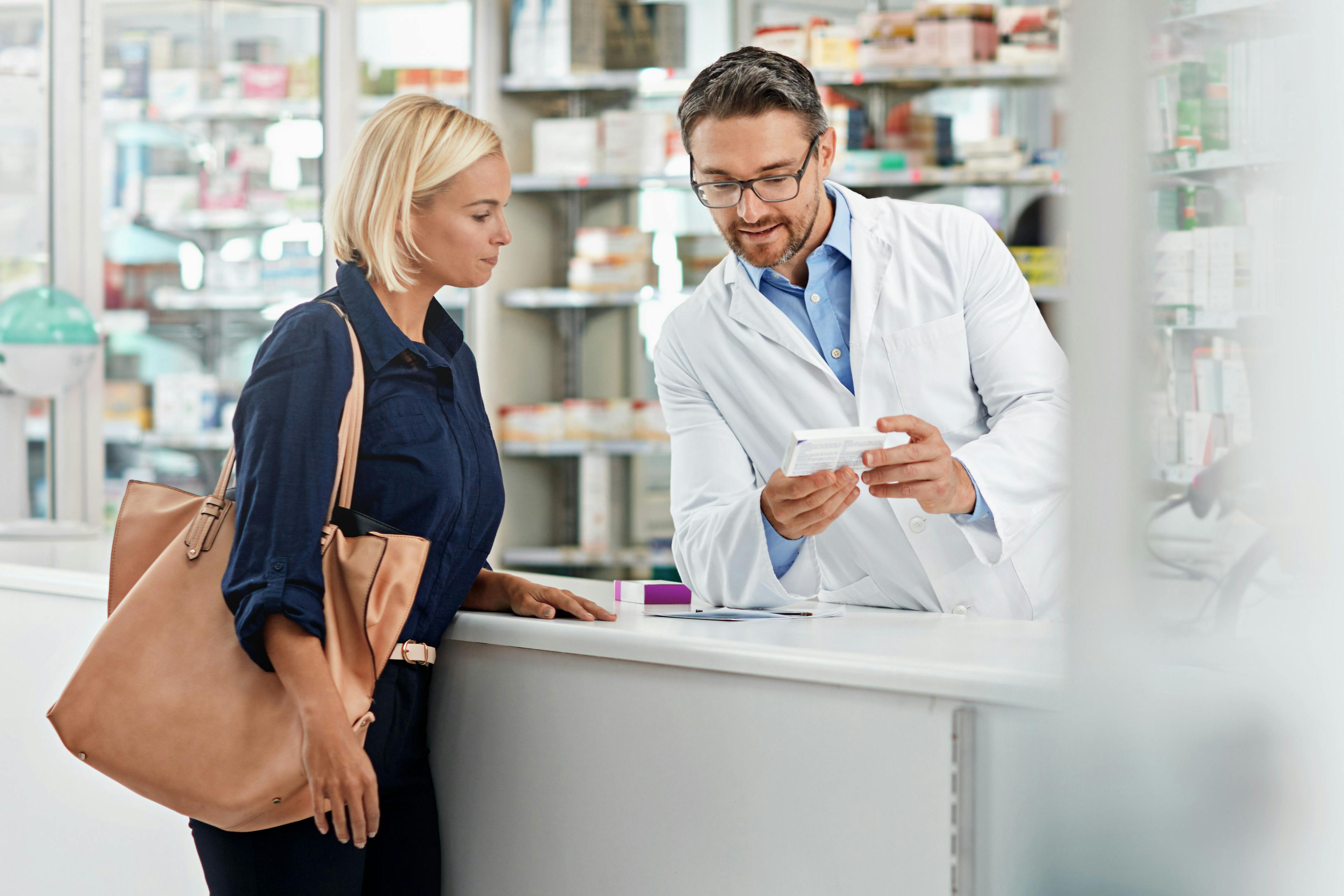 Pharmacist helping a customer, health care advice, pharmacy