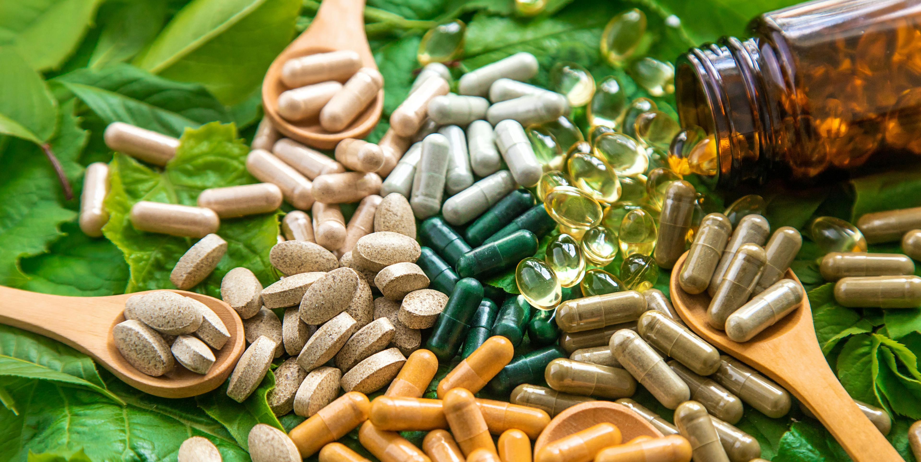 Capsules herb supplements on green leaves background. Selective focus - Image credit: yanadjan | stock.adobe.com 